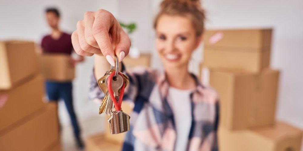 Woman's hand showing keys from new apartment